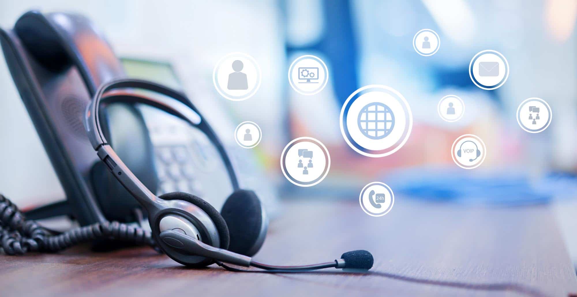 close up focus on call center headset device at VOIP system on telephone machine with virtual interface of communication at office desk for hotline telemarketing and network operation concept close up focus on call center headset device at VOIP system on telephone machine with virtual interface of communication at office desk for hotline telemarketing and network operation concept